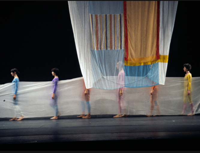 A group of people holding a curtain

Description automatically generated
