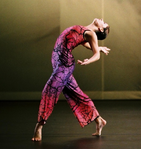 A person dancing on a stage

Description automatically generated