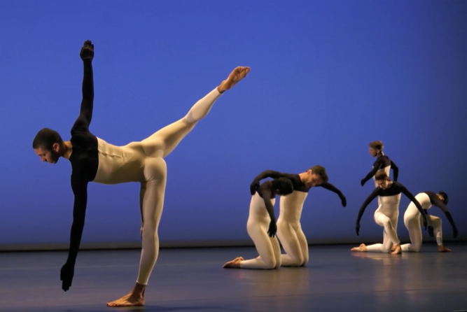 A group of people performing on stage

Description automatically generated