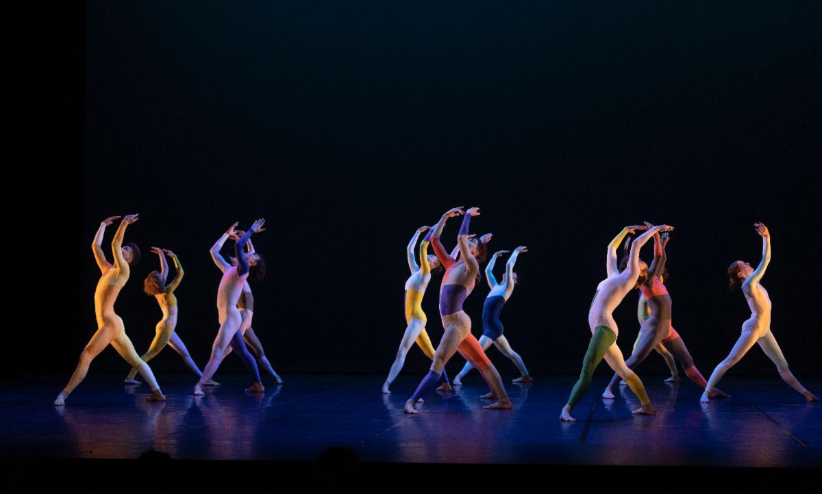 A group of people dancing on a stage

Description automatically generated