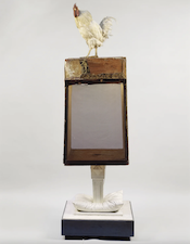 A chicken standing on a sign

Description automatically generated