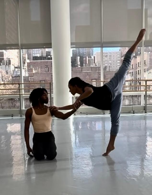 A person stretching another person

Description automatically generated