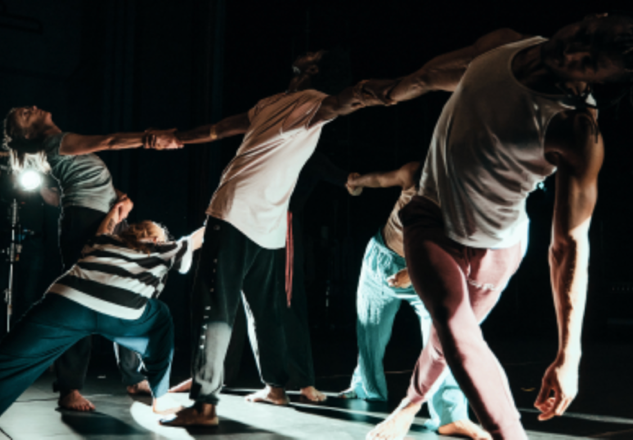 A group of people dancing on a stage

Description automatically generated