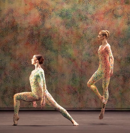 Two women in body suits dancing

Description automatically generated