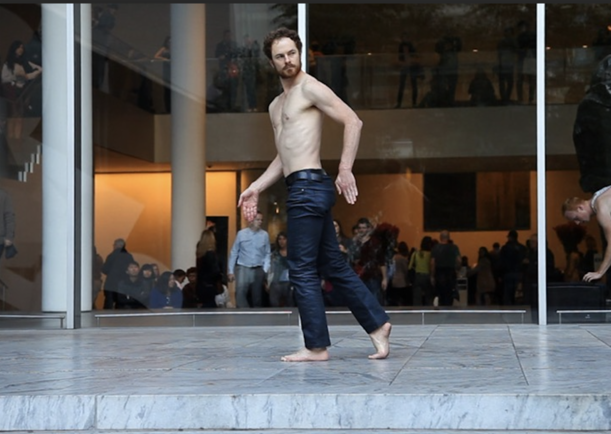 A person walking on a stone platform

Description automatically generated