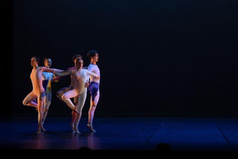 A group of people dancing on a stage

Description automatically generated